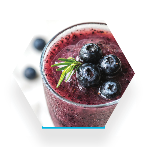 image of a blueberry based smoothie in a clear glass with a sprig of rosemary