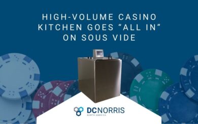 a navy blue background with many colorful poker chips on it is behind a shiny stainless steel CT-1 sous vide cook tank. The cook tank if below a headline that reads" high-volume casino kitchen goes all in on sous vide" and above the DC Norris North America logo