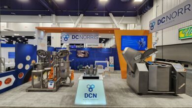 DC Norris North America's fully set up trade show booth at Pack Expo Las Vegas 2025 in the Processing Zone.