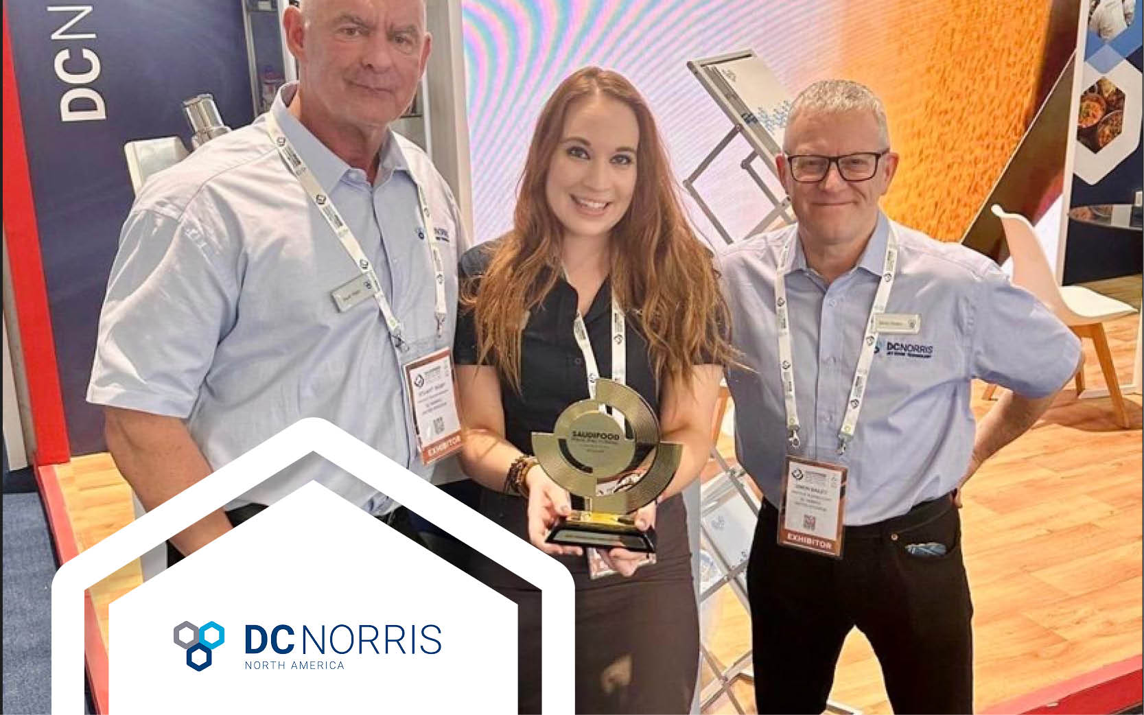 DC Norris team (3 people) are standing in front of their booth at the 2024 SaudiFood Manufacturing Show holding the award they won for Best In Processing Innovation