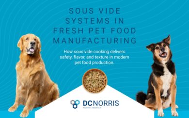 Two dogs beside a bowl of fresh cooked pet food with the text “Sous Vide Systems in Fresh Pet Food Manufacturing.” DC Norris North America provides advanced sous vide equipment that improves safety, flavor, and texture in modern pet food production.