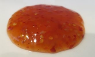 close up shot of sweet chili dipping sauce dabbed on a plate after a successful trial production run