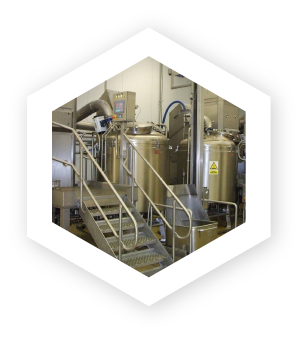 stairs lead up to a bank of stainless steel industrial vacuum cooling units